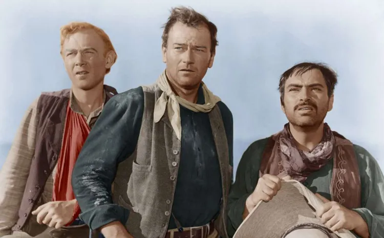 Tres cowboys miran al horizonte