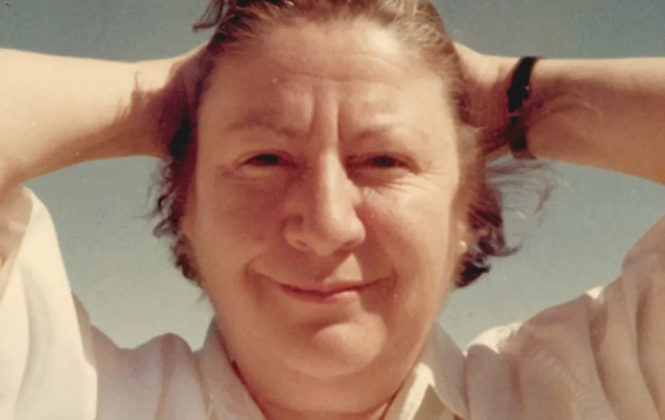 Mujer sonríe con las manos tras la nuca