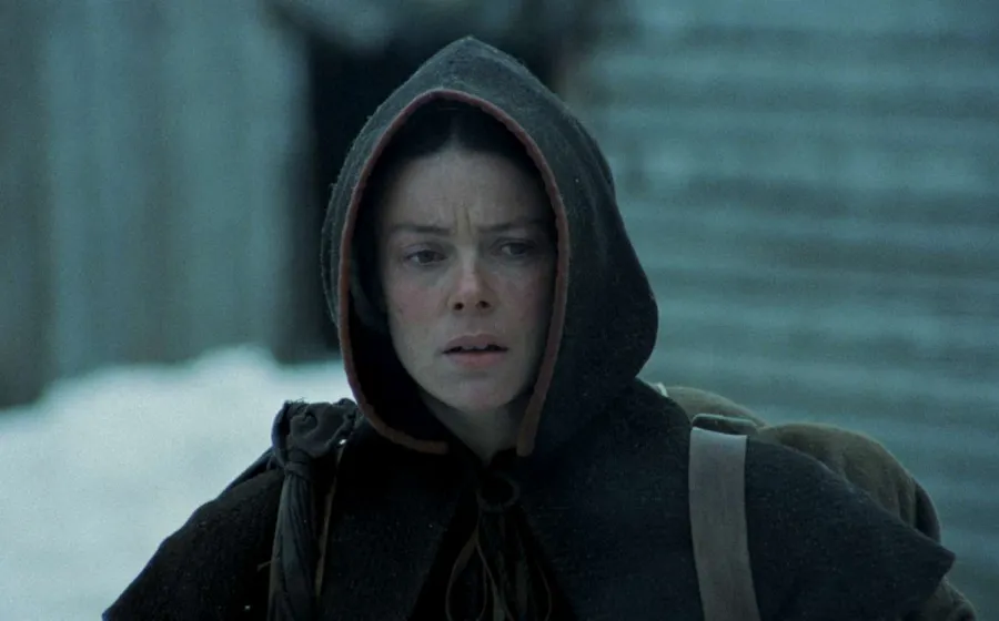 Chica con sudadera con fondo urbano nevado